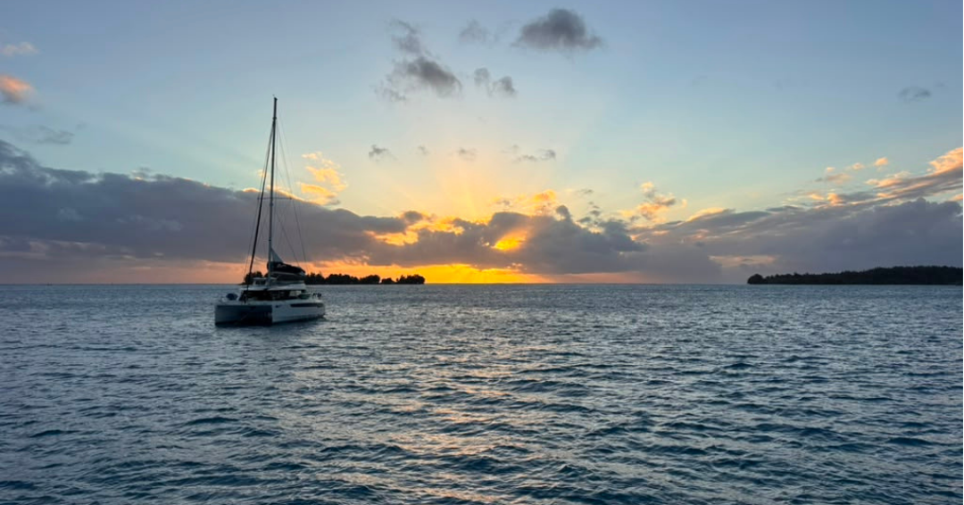 Sunset catamaran sailing Society Islands 2026