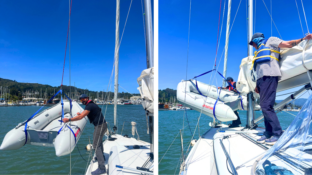 Quartermaster Michael Carney and Capt. Timon Eatherton hoist a dinghy from Andiamo's deck
